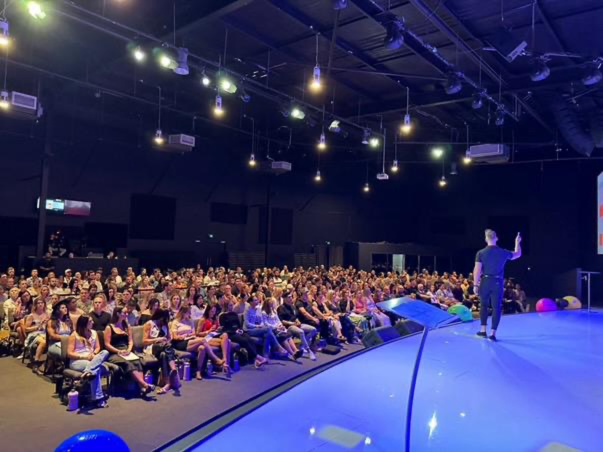 Dr Dan addressing a packed venue